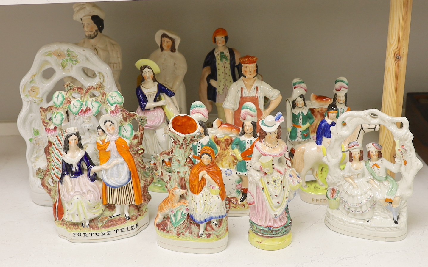 A group of Staffordshire pottery and porcellaneous figures and groups, The tallest 42 cm